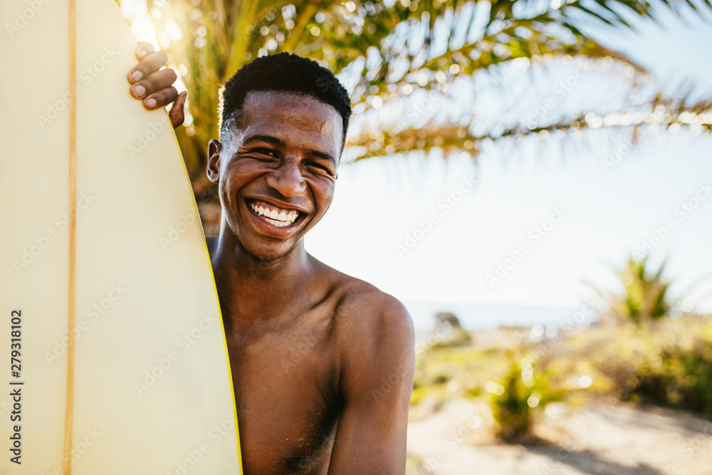 hawaiian man with surfboard