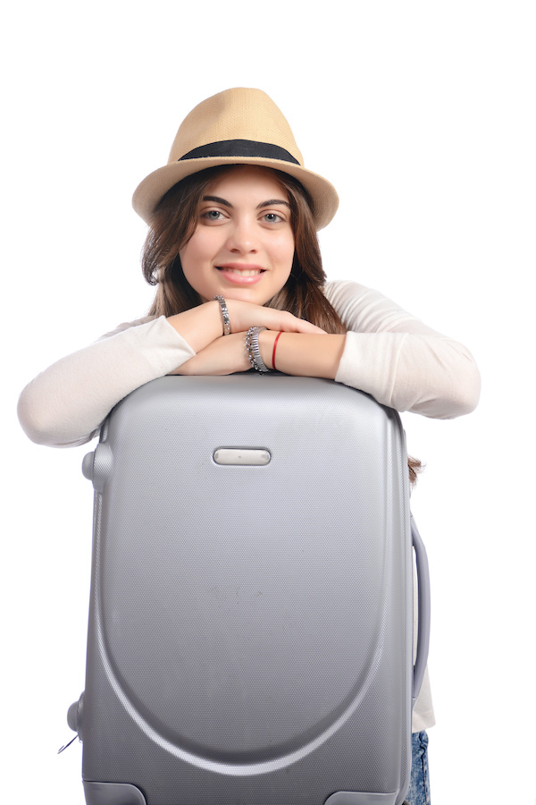 Women with suitcase and hat